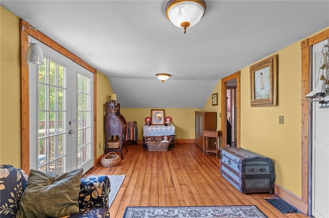 48 Highview Ave, Hopkinton, RI 02832 - bedroom with access to exterior, light wood finished floors, baseboards, vaulted ceiling, and french doors