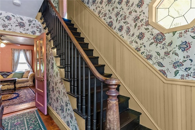 48 Highview Ave, Hopkinton, RI 02832 - stairway featuring wallpapered walls, wood finished floors, a wainscoted wall, and a ceiling fan