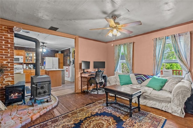 48 Highview Ave, Hopkinton, RI 02832 - living area featuring a ceiling fan, wood-type flooring, a wood stove, an office area, and ornamental molding