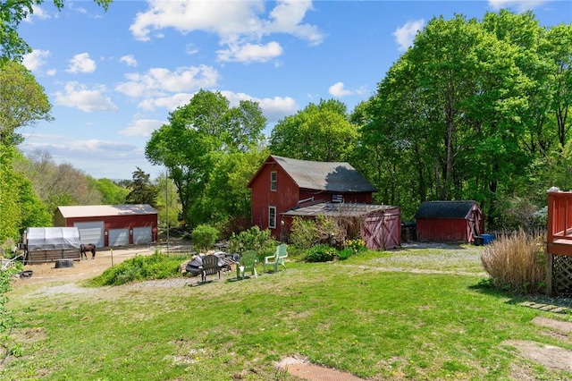 48 Highview Ave, Hopkinton, RI 02832 - view of grassy yard featuring an outbuilding, a detached garage, a shed, and driveway