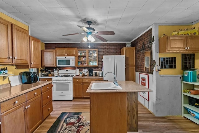 48 Highview Ave, Hopkinton, RI 02832 - kitchen with white appliances, a sink, brick wall, a ceiling fan, and light wood finished floors