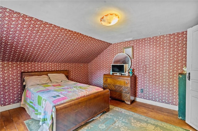 48 Highview Ave, Hopkinton, RI 02832 - bedroom featuring wallpapered walls, wood-type flooring, baseboards, and vaulted ceiling
