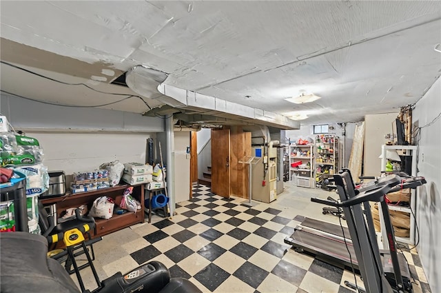 basement with heating unit, tile patterned floors, and stairs