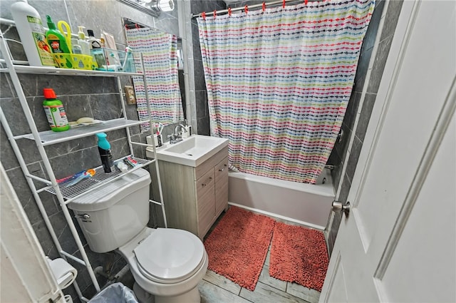 full bathroom featuring toilet, tile walls, shower / bath combo, and vanity