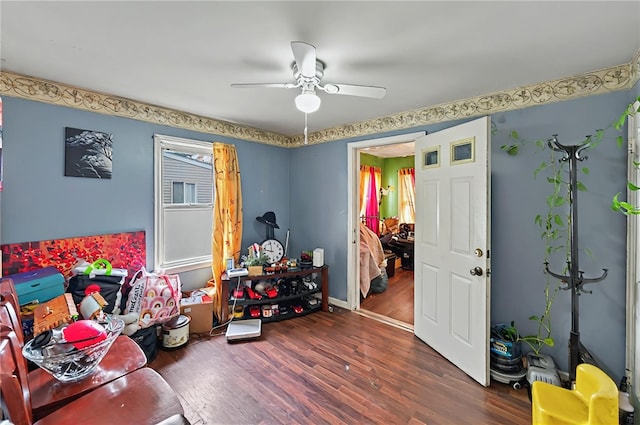 game room featuring a ceiling fan, baseboards, and wood finished floors