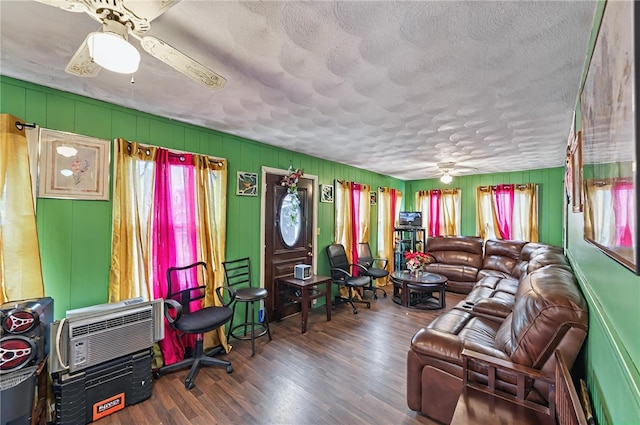 living area featuring a textured ceiling, wood finished floors, and a ceiling fan