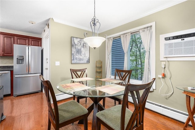 dining room featuring light wood-style flooring, baseboard heating, ornamental molding, and an AC wall unit