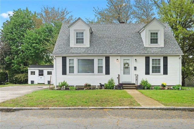 141 Burns St, Providence, RI 02904 - cape cod-style house with a front yard, roof with shingles, and entry steps