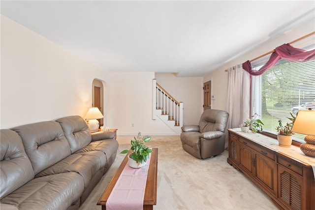 141 Burns St, Providence, RI 02904 - living area with light colored carpet, stairs, arched walkways, and baseboards