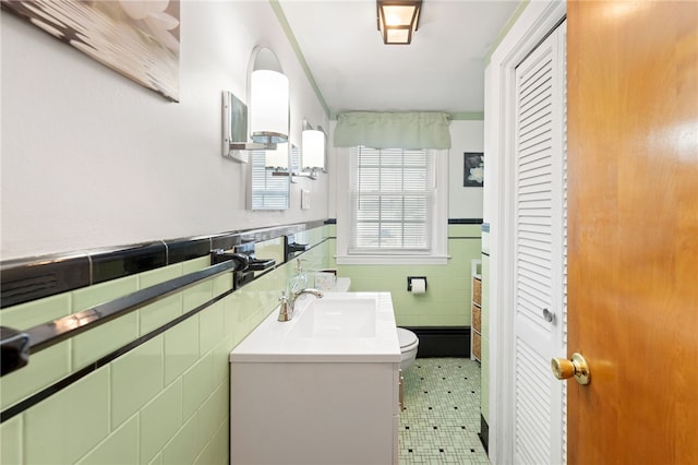 141 Burns St, Providence, RI 02904 - bathroom featuring tile walls, a closet, toilet, wainscoting, and vanity