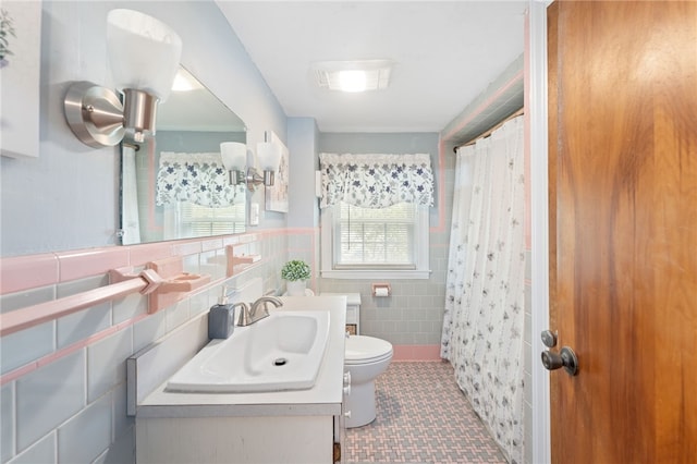 141 Burns St, Providence, RI 02904 - full bathroom featuring tile walls, toilet, wainscoting, tile patterned floors, and vanity
