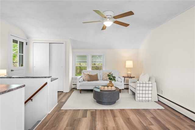 living area featuring wood finished floors, a ceiling fan, baseboard heating, a baseboard heating unit, and lofted ceiling