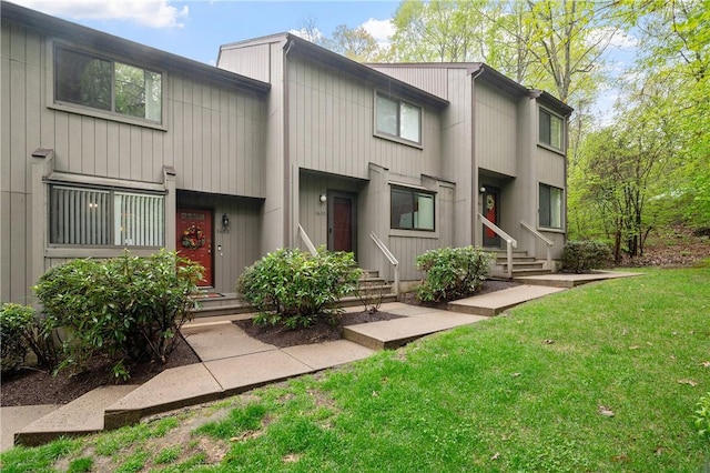 back of property featuring a yard