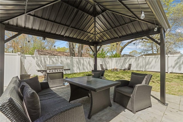 view of patio / terrace featuring a gazebo, area for grilling, and a fenced backyard