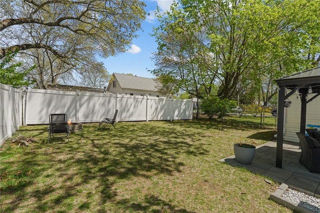 view of yard featuring a fenced backyard, a gazebo, and a patio area