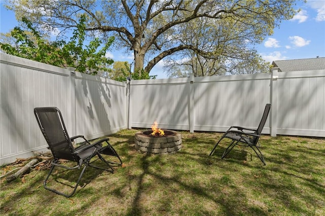 view of yard with a fenced backyard and an outdoor fire pit