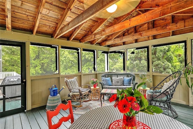 sunroom / solarium featuring vaulted ceiling and an outdoor living space