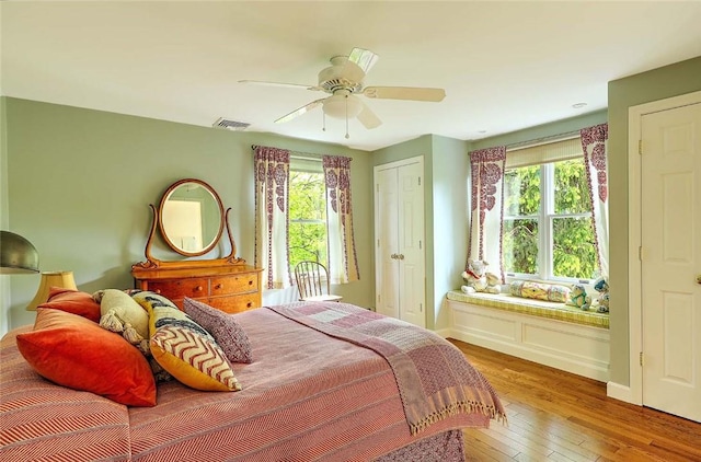 bedroom featuring wood-type flooring, ceiling fan, and baseboards