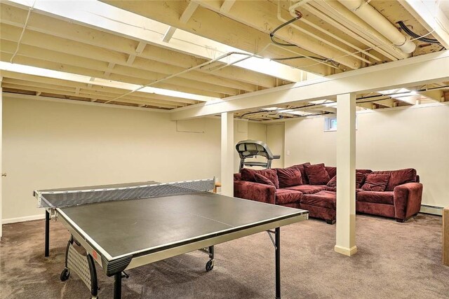 game room featuring carpet floors and a baseboard heating unit