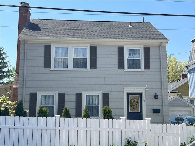 135 Cypress St, Providence, RI 02906 - colonial inspired home featuring a shingled roof, fence, and a chimney