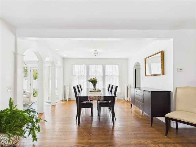 135 Cypress St, Providence, RI 02906 - dining area with arched walkways, radiator heating unit, recessed lighting, and wood finished floors