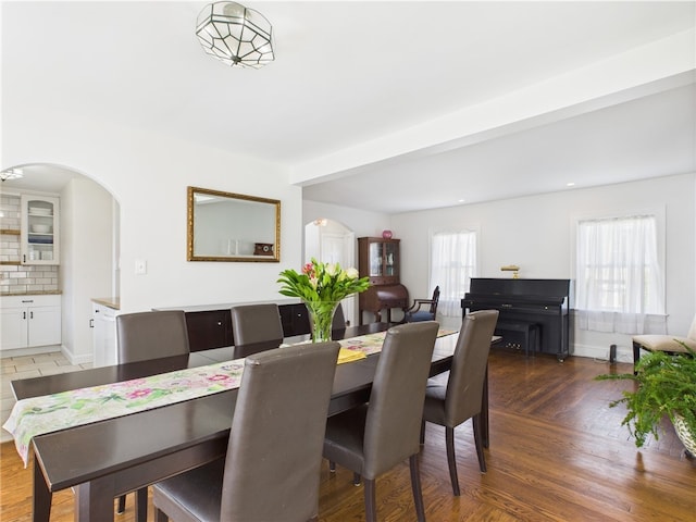 135 Cypress St, Providence, RI 02906 - dining area with light wood-style flooring, baseboards, and arched walkways