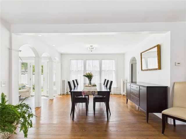 135 Cypress St, Providence, RI 02906 - dining area with wood finished floors, arched walkways, a healthy amount of sunlight, and decorative columns
