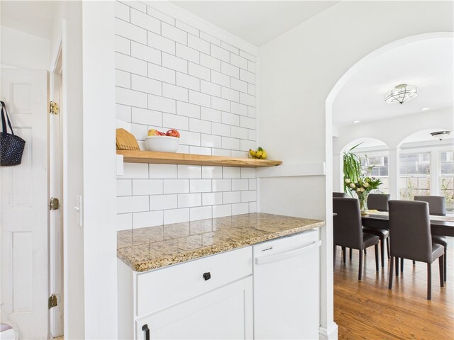 135 Cypress St, Providence, RI 02906 - bar with backsplash, white dishwasher, light wood-style flooring, and arched walkways