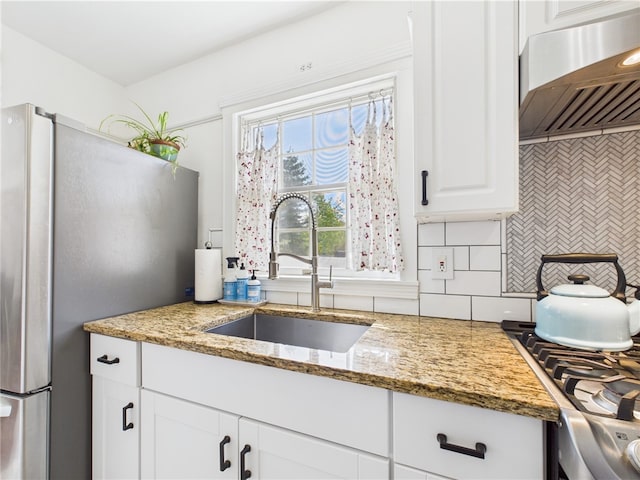 135 Cypress St, Providence, RI 02906 - kitchen featuring a sink, freestanding refrigerator, ventilation hood, decorative backsplash, and white cabinets