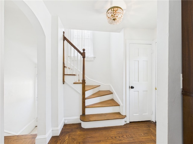 135 Cypress St, Providence, RI 02906 - stairway with arched walkways, baseboards, and a notable chandelier