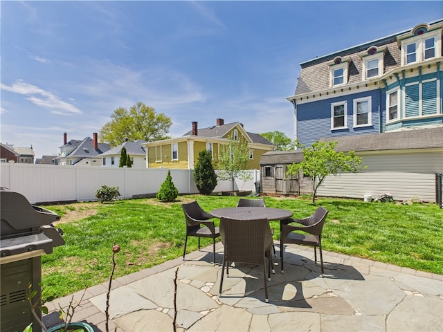 135 Cypress St, Providence, RI 02906 - view of patio / terrace featuring an outdoor structure, a shed, a fenced backyard, grilling area, and outdoor dining area