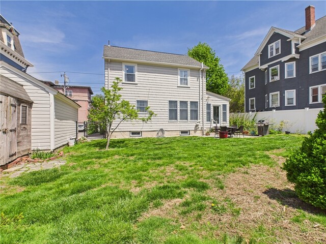 135 Cypress St, Providence, RI 02906 - rear view of property with a yard, fence, and a patio area