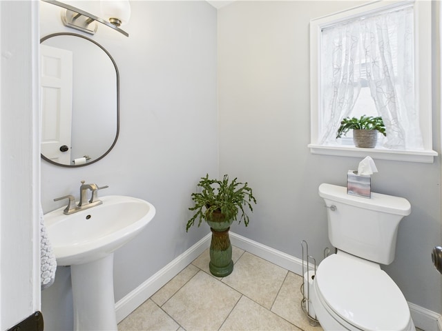 135 Cypress St, Providence, RI 02906 - half bath featuring toilet, baseboards, tile patterned flooring, and a sink