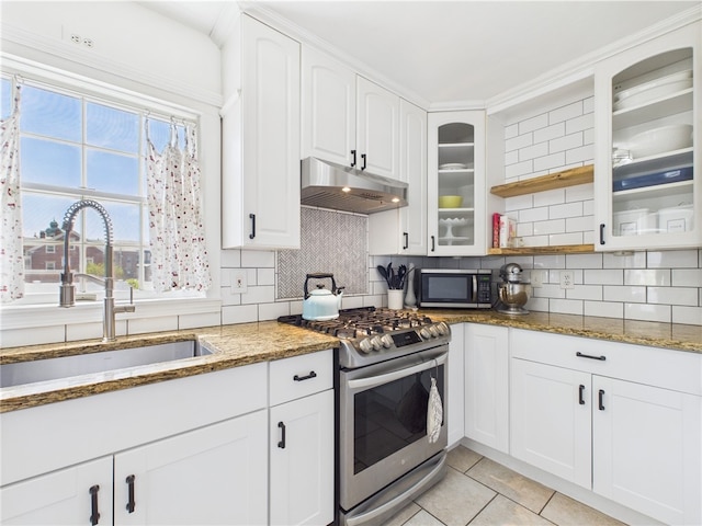 135 Cypress St, Providence, RI 02906 - kitchen featuring a sink, stone countertops, under cabinet range hood, glass insert cabinets, and appliances with stainless steel finishes