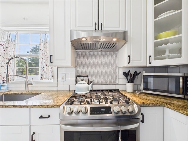 135 Cypress St, Providence, RI 02906 - kitchen with a sink, extractor fan, white cabinetry, and appliances with stainless steel finishes
