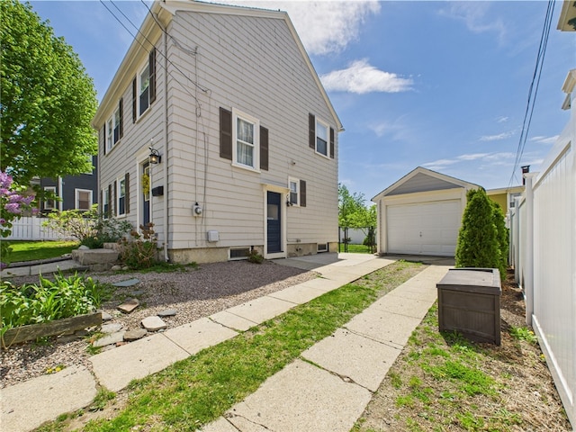 135 Cypress St, Providence, RI 02906 - view of side of property with an outdoor structure, fence, and a garage
