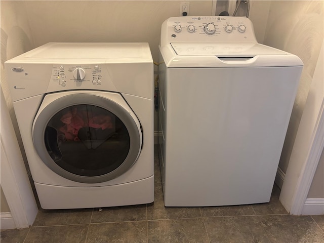 clothes washing area with laundry area, washer and clothes dryer, and tile patterned flooring