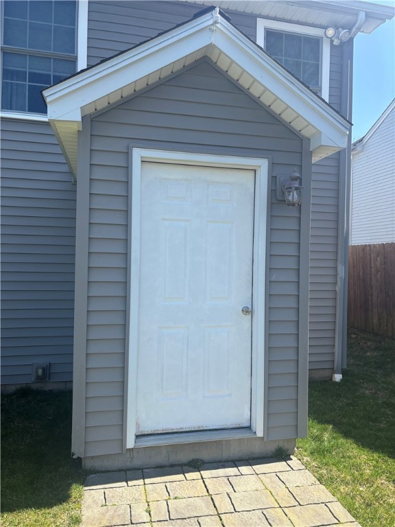 exterior space with a storage shed and fence