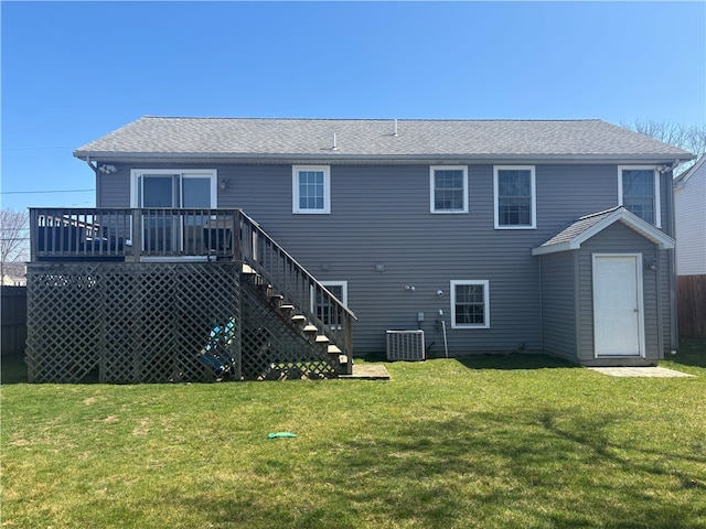 rear view of property with a yard, stairs, central AC unit, and a wooden deck