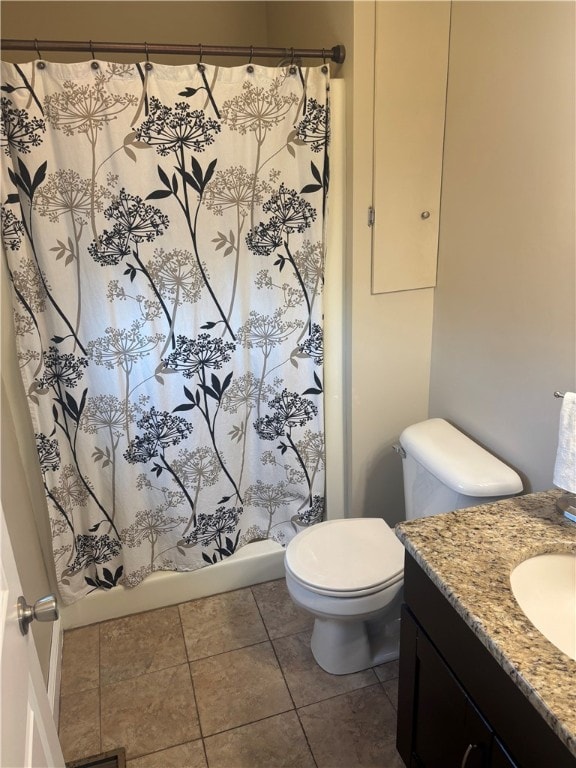 bathroom featuring toilet, tile patterned floors, and vanity