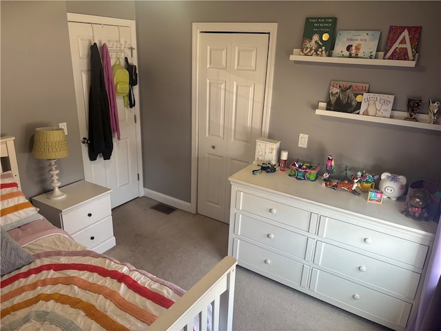 bedroom with carpet flooring, a closet, baseboards, and visible vents