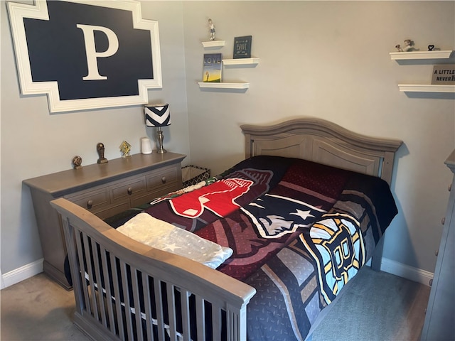 carpeted bedroom featuring baseboards