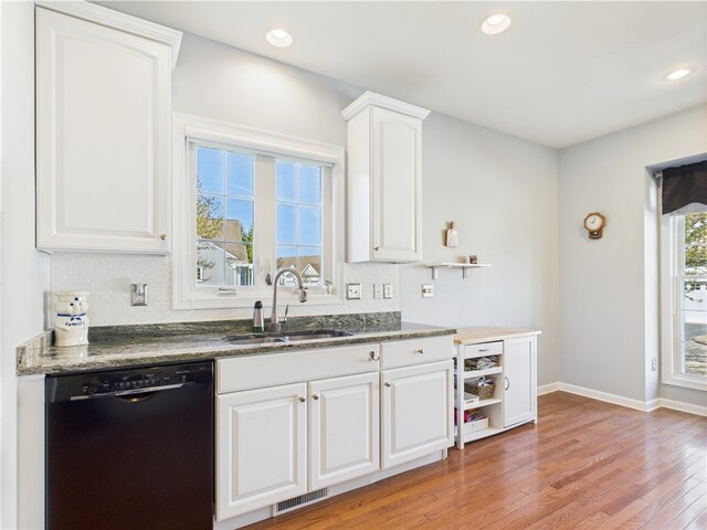 6 Yarmouth Cir S, Kingstown, RI 02879 - kitchen with a sink, black dishwasher, light wood-type flooring, visible vents, and white cabinetry