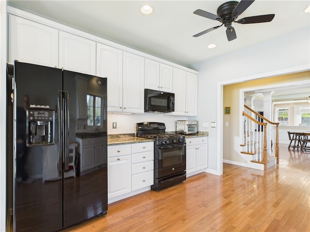 6 Yarmouth Cir S, Kingstown, RI 02879 - kitchen with stone counters, black appliances, ornate columns, and white cabinets