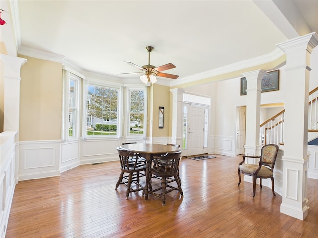 6 Yarmouth Cir S, Kingstown, RI 02879 - dining room featuring decorative columns, a decorative wall, a ceiling fan, and stairs