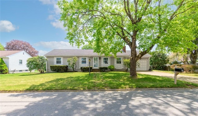ranch-style house with a garage, a front yard, a chimney, and driveway