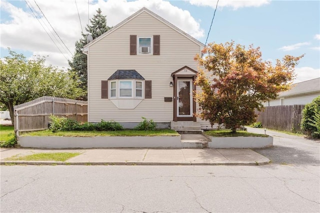 view of front of home featuring cooling unit, fence, and entry steps