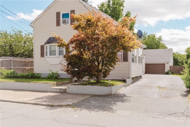 view of front of property with fence and a garage