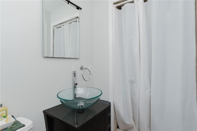 bathroom featuring vanity and curtained shower