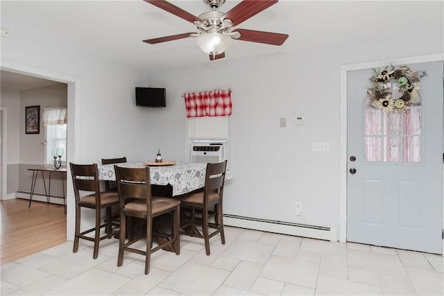 dining room with ceiling fan, a baseboard heating unit, and cooling unit